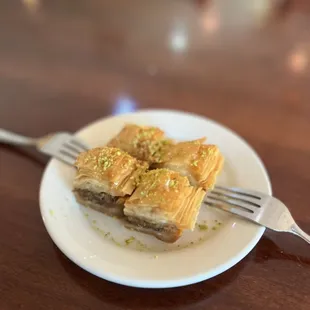 a piece of baklai on a plate with a fork