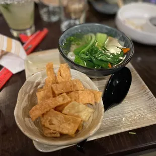a bowl of chips and a bowl of salad