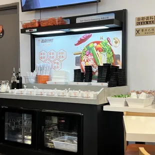 Seasoning station, next to Toilet hallway entrance.  Fortune cookies &amp; hard candies next to station.