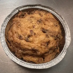 a chocolate chip cookie in a tin