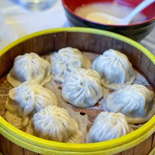 a bowl of dumplings and a bowl of soup
