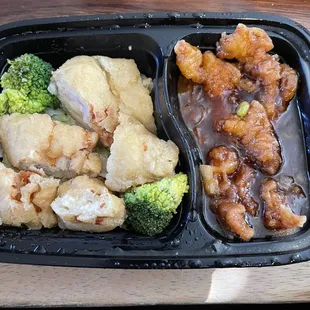 Lemon chicken (sauce is on side), not sure what is on the right side.