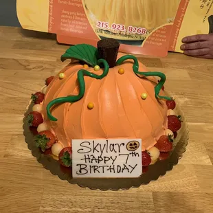 a birthday cake with a pumpkin on it