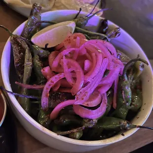 a bowl of onions and peppers