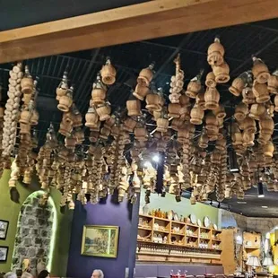 a restaurant with a large amount of food hanging from the ceiling