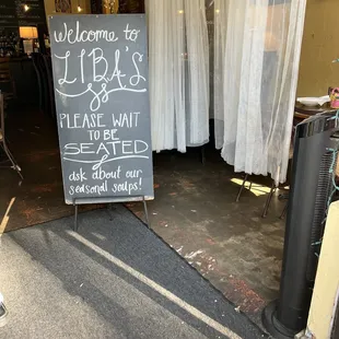 a chalkboard sign in front of a restaurant