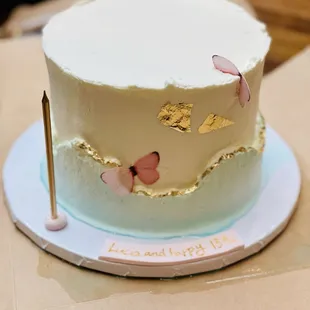 a birthday cake with butterfly decorations