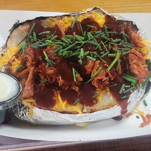Giant loaded baked potato with smoked ham and hot BBQ sauce, outstanding.