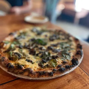 a pizza on a wooden table