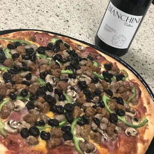 All meat pizza with some extra veggies added paired with a nice red wine from Olive Crush (next door)