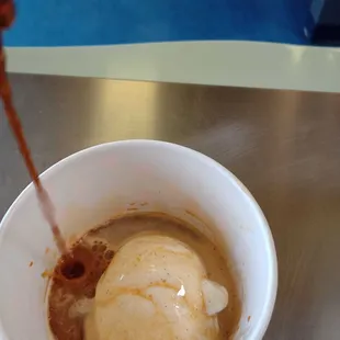 Affogato hot espresso with scoop of cold frozen yogurt