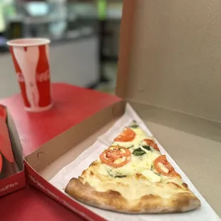 a slice of pizza in a box