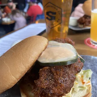 a chicken sandwich with a pickle on a bun