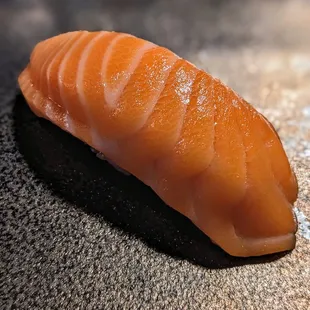 a piece of sushi on a table