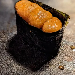 a piece of sushi on a table
