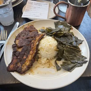 Blackened catfish with grits and greens.