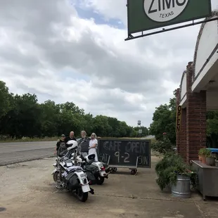 two motorcycles parked in front of a restaurant