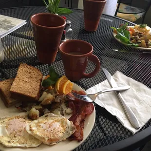 The basic bacon, eggs (over medium &amp; done right), potatoes and wheat toast. All perfectly done.