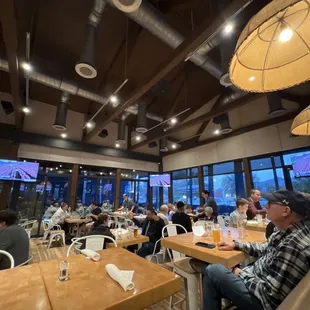 people sitting at tables in a restaurant