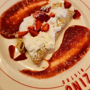 a plate of food with strawberries and cream