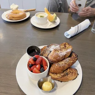 French Toast in the front, toasted Bagel and poached egg in the back. The French toast is so surprisingly light and airy! Loved it