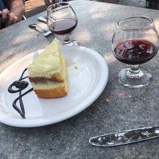 a piece of cheesecake and a glass of wine