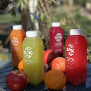 a variety of juices on a picnic table
