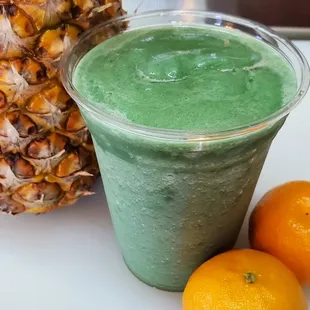 a pineapple and two oranges