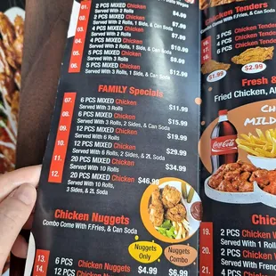 a hand holding a menu