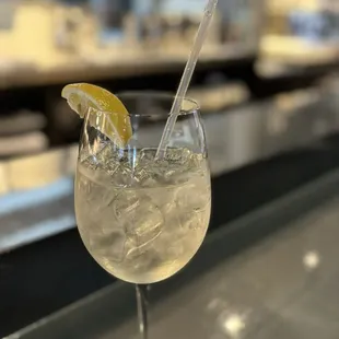 a glass of lemonade on a bar