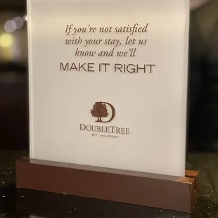 a sign that says, if you&apos;re not satisfied with your stay, let us know and we &apos;
