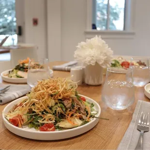 a plate of salad and a glass of water