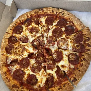 Little undercooked pepperoni pizza in middle.