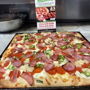 Sicilian Hawaiian Pizza with pepperoni, jalapeños, pineapple and ham.  Delicious!!