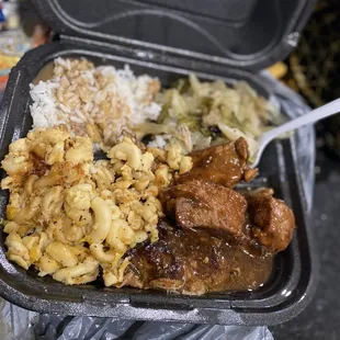 Rice with gravy, macaroni and cheese, bbq chicken, cabbage