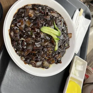 a bowl of soup and a fork on a tray