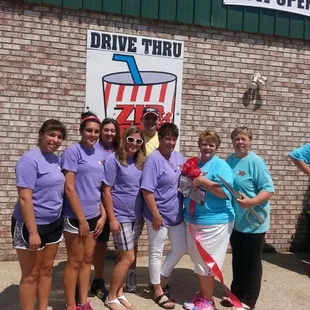a group of people standing in front of a store