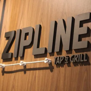 zipline tap and grill signage