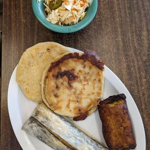 Combo plate 2 Papusas, a chicken Tamal, and a sweet milk Empanada with Cole slaw.