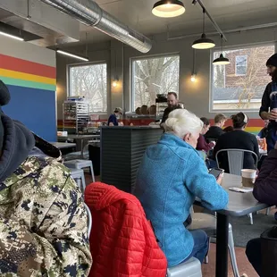 people sitting at tables in a cafeteria