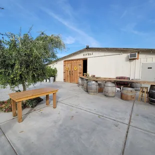 a patio with a table and barrels