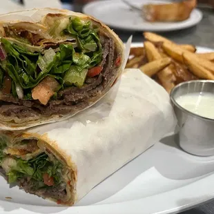 Zizi&apos;s Favorite Doner Wrap. Thin dough topped with seasoned ground beef and mozzarella cheese, Doner (A homemade Gyro)