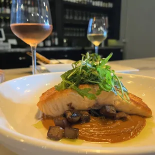  a plate of food and a glass of wine