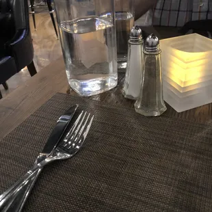  a glass of water and salt and pepper shakers