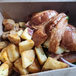 Breakfast sandwich with bacon and fried potatoes