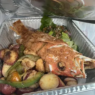 Whole red snapper, potatoes, and salad