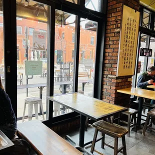 a woman sitting at a table in a restaurant