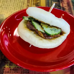 a bun on a red plate