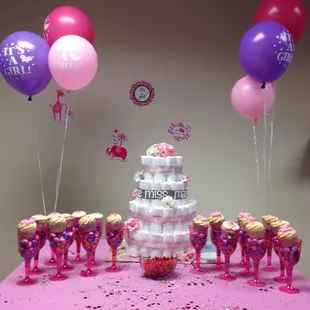 a pink table with balloons