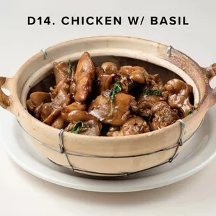 a dish of chicken with basil